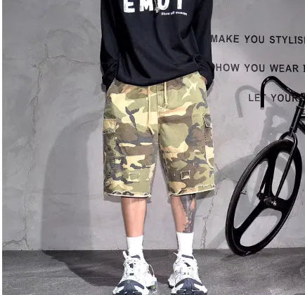 Man wearing loose-fit cropped camouflage shorts in a retro workwear style.