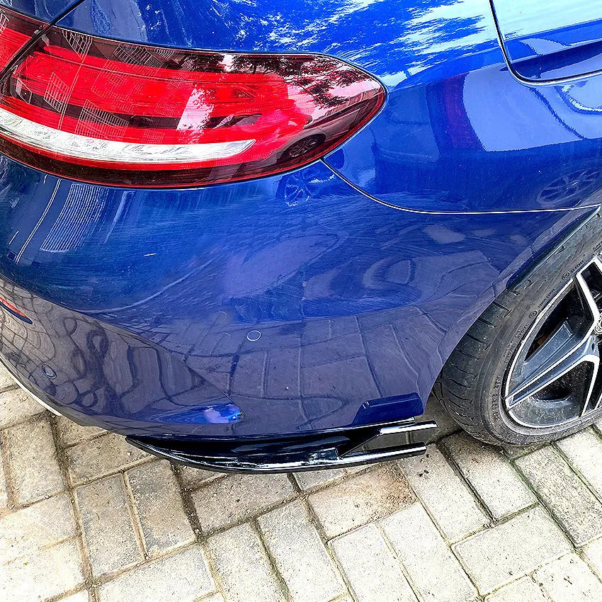 Car rear corner protectors in PP plastic, shown in piano black and carbon fibre pattern finishes