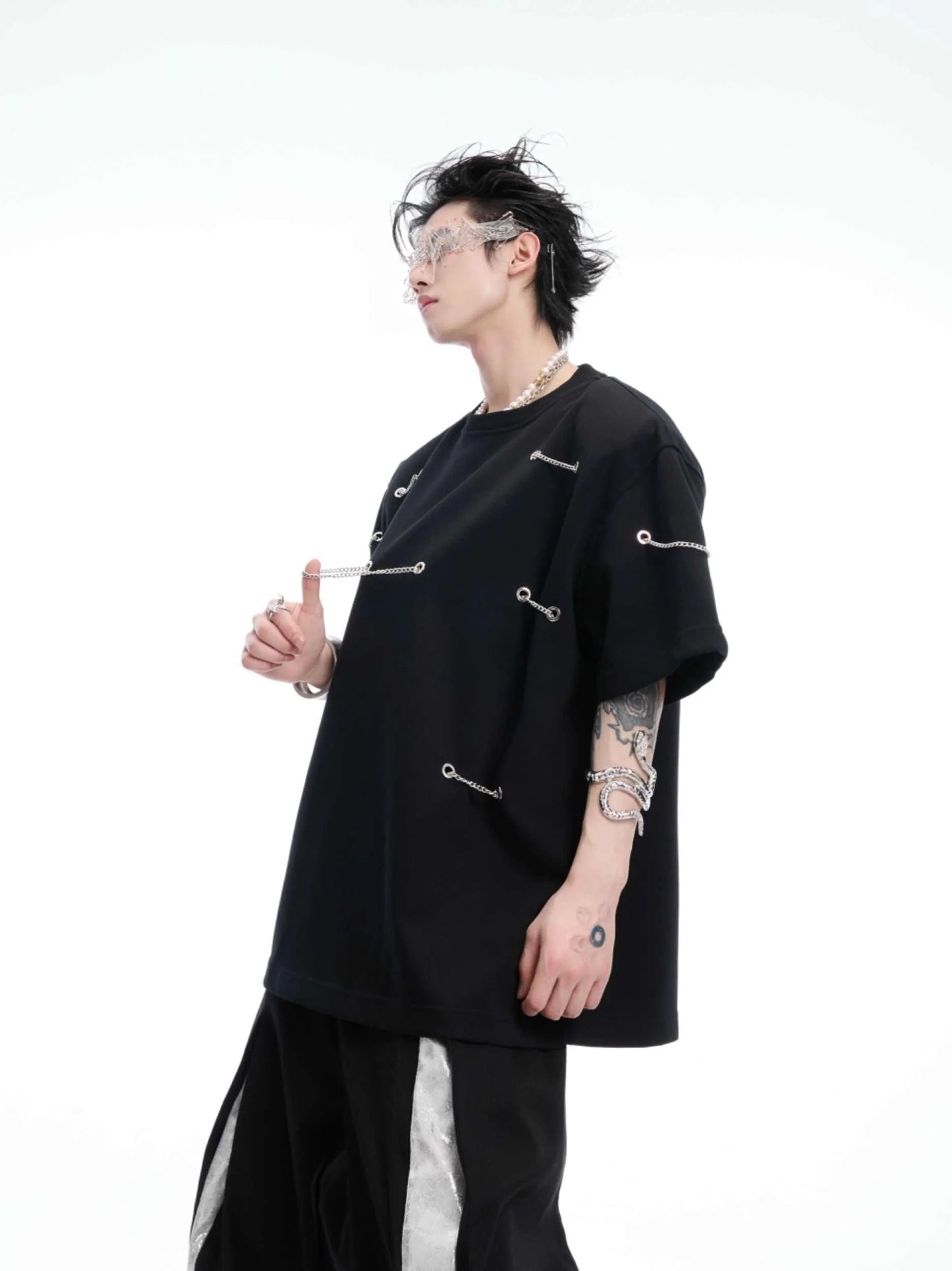 Black men's t-shirt with metal chain and padded shoulder detail on a short sleeve cotton-polyester blend.