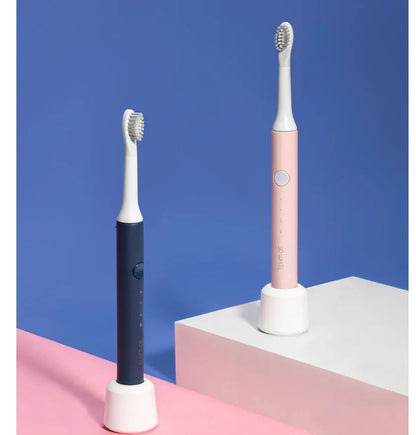 SOOCAS sonic electric toothbrush in blue or pink with round brush head on a bathroom counter.