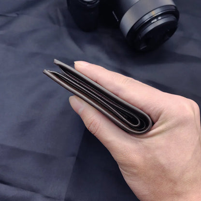 Men's leather wallet with zipper closure, presented in individual packaging.