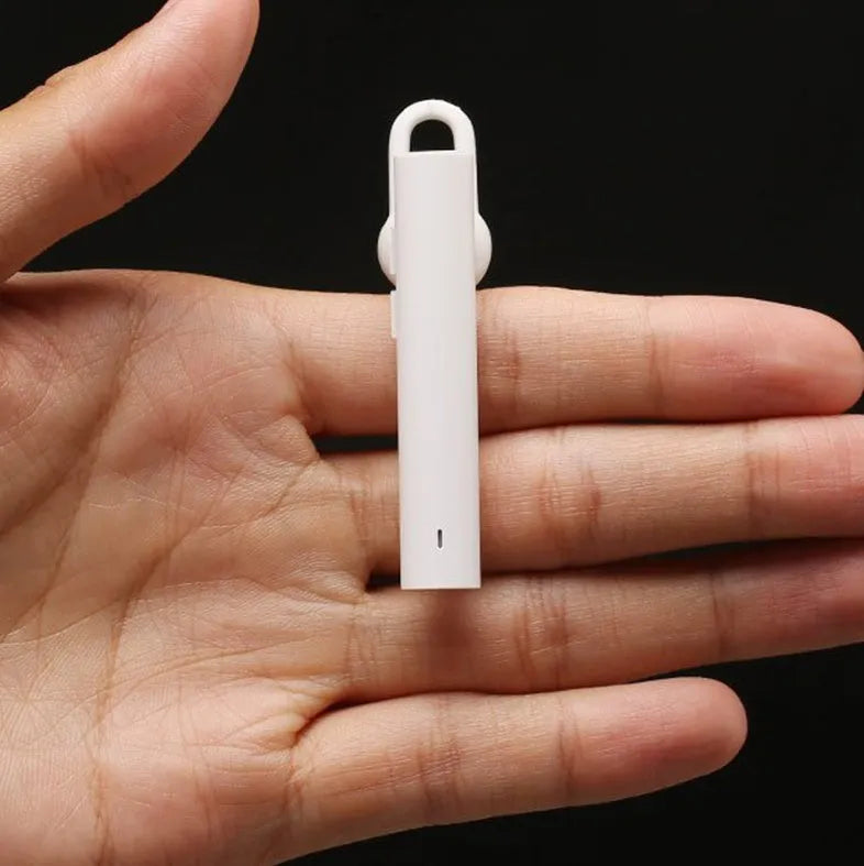 Black wireless Bluetooth headset showing compact 5.6cm design with charging cable