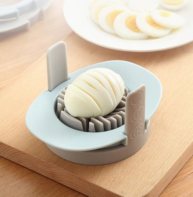 Three-function manual egg cutter in blue with stackable design for kitchen use