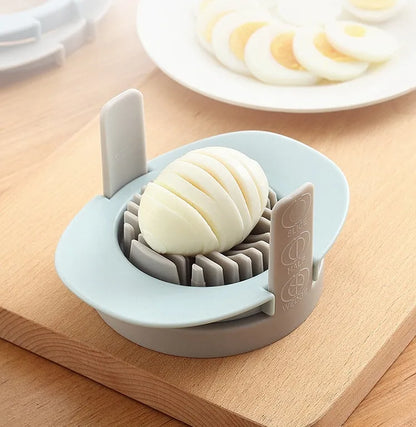 Three-function manual egg cutter in blue with stackable design for kitchen use