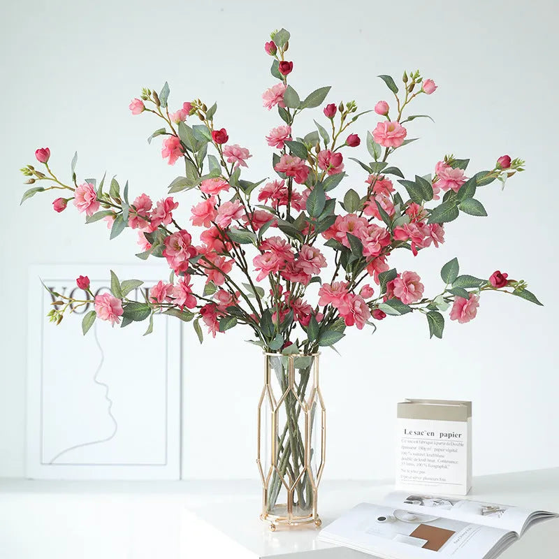 Artificial silk camellia flower in a vase, colours include white, pink, rose pink, and orange coffee.