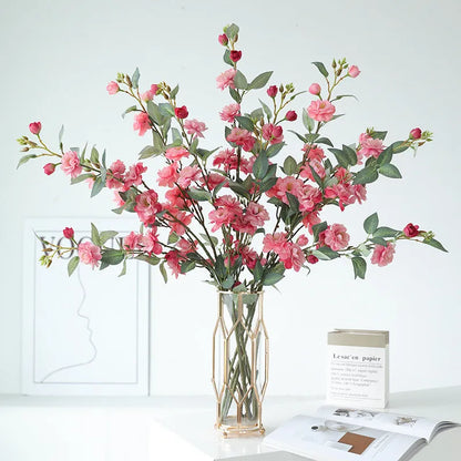 Artificial silk camellia flower in a vase, colours include white, pink, rose pink, and orange coffee.