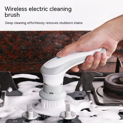 White cordless electric spin scrubber with multiple brush heads on a bathroom tile.