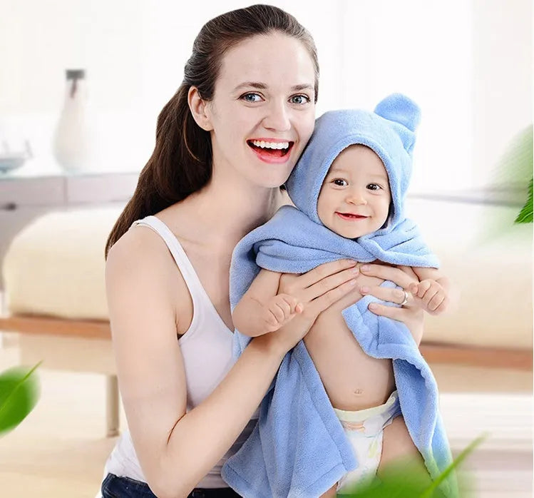 Blue hooded baby bath towel with dimensions 65cm by 110cm laid flat.
