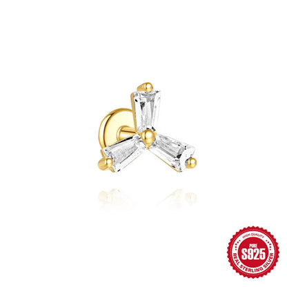 Close-up of a sterling silver double piercing chain stud earring with inlaid zircon stone in a golden colour.