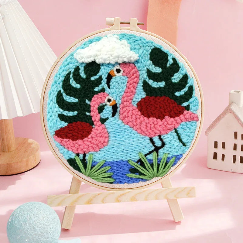 Handmade embroidery kit with cartoon animal designs on linen fabric including flamingo, whale and deer patterns