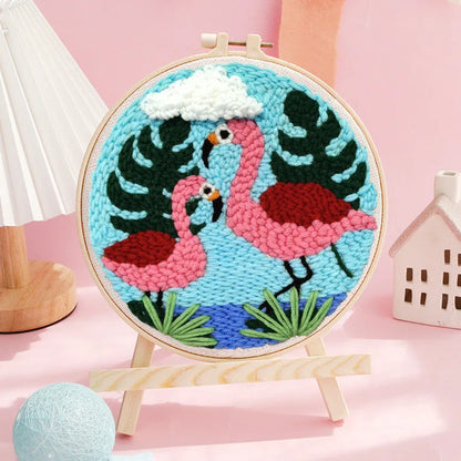 Handmade embroidery kit with cartoon animal designs on linen fabric including flamingo, whale and deer patterns
