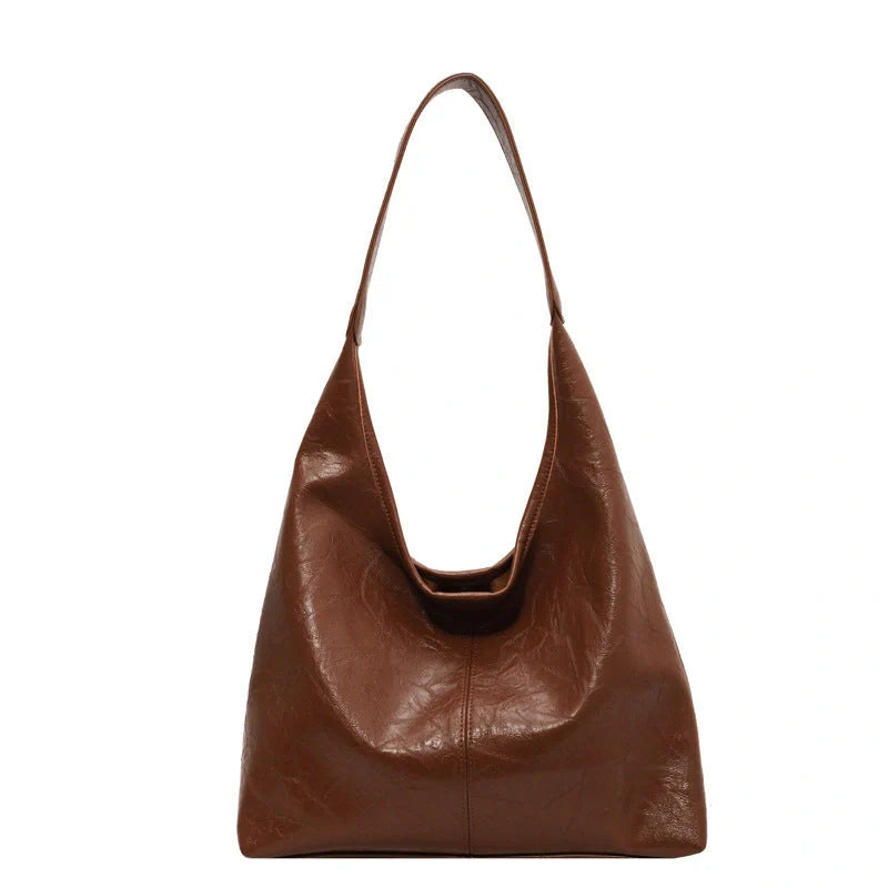 Classic vintage-inspired women's shoulder bag in a range of sophisticated colours, featuring a roomy interior, adjustable strap, and premium materials for timeless British style.