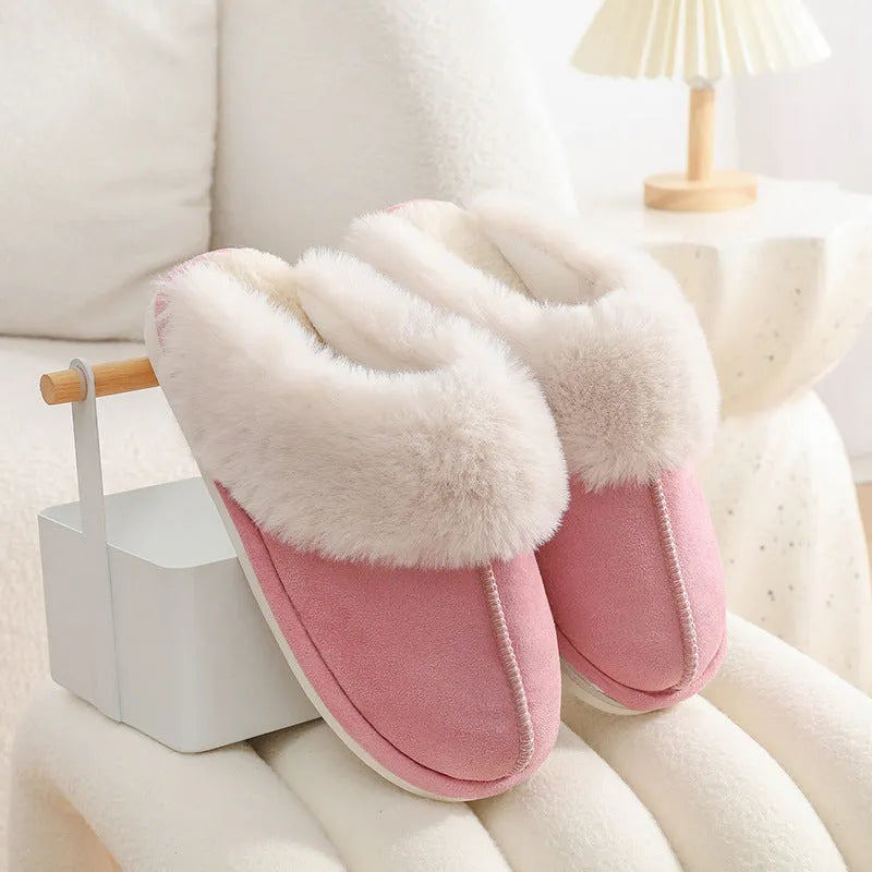 Women's plush winter slippers with round toe, flat heel, and stitching detail on a non-slip PVC sole.