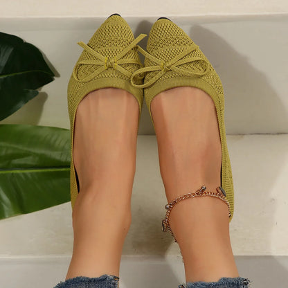 Women's blue knitted loafer flat shoes with a pointed toe and decorative bow detail on the front.