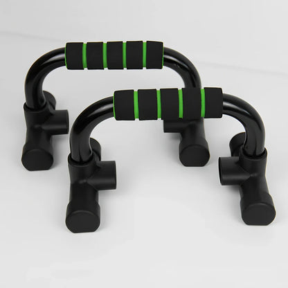Green suction cup push-up bracket with electroplated steel frame and foam grips, supporting 300kg for chest training on floors