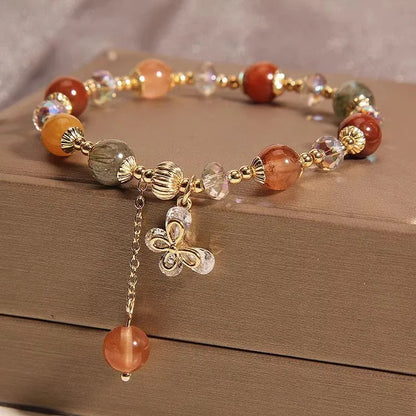 Colourful hair crystal stretch bracelet with cat's paw, butterfly, flower, and purse charms on adjustable band