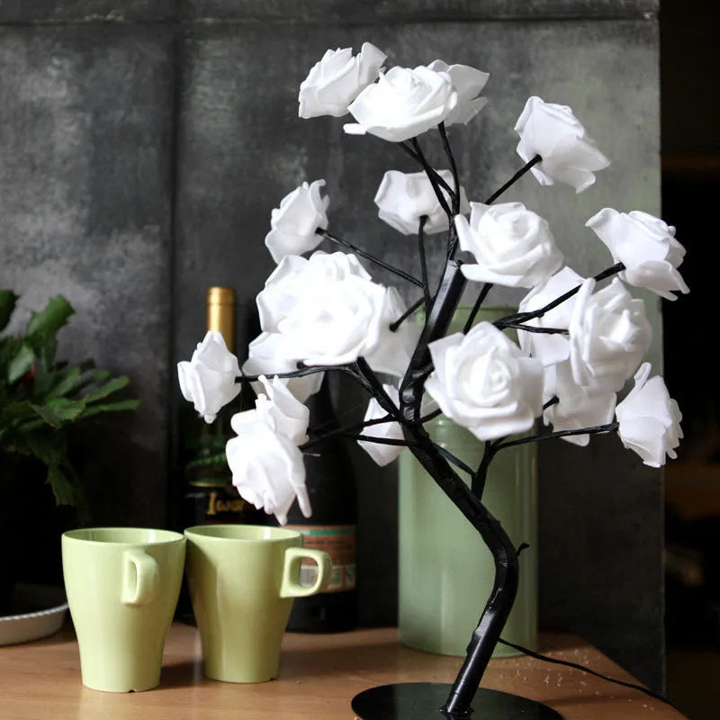 White and red rose flower LED lamp on a table with bonsai tree shape and warm white glow.