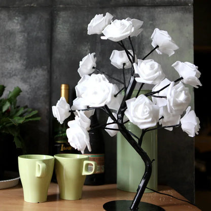 White and red rose flower LED lamp on a table with bonsai tree shape and warm white glow.