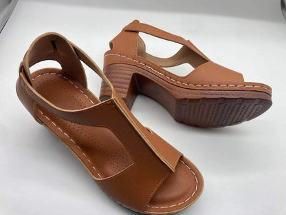Women's beige peep toe wedge sandals with a buckle strap and low heel on a white background.