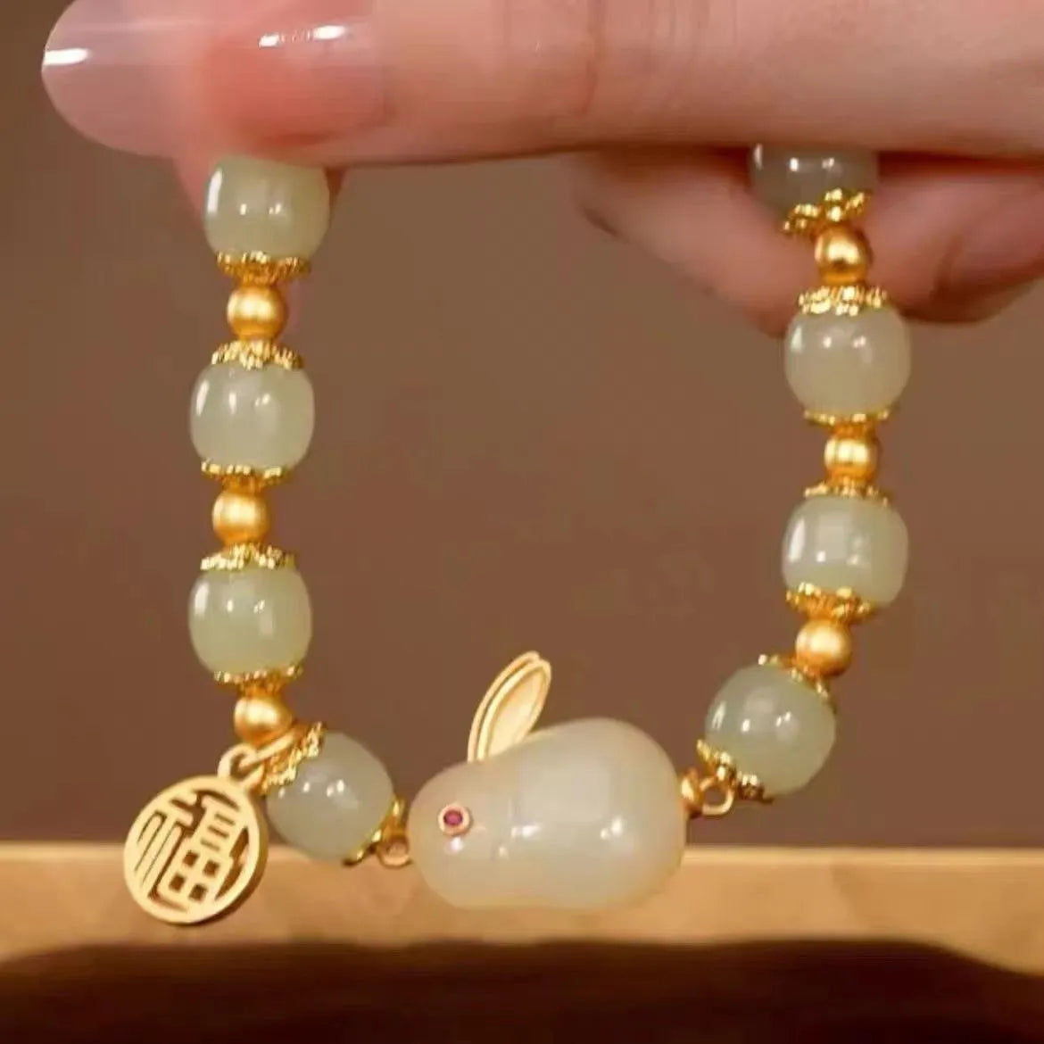 Green jade Lucky Hare charm bracelet with black cord and lily engraving.