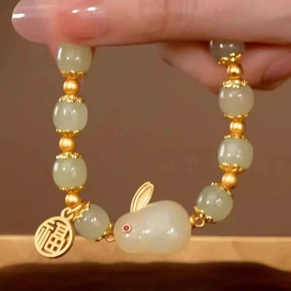 Green jade Lucky Hare charm bracelet with black cord and lily engraving.