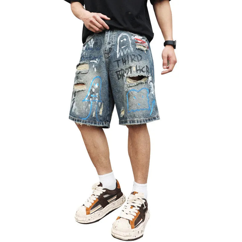 Blue men's jeans shorts with ripped distressed detailing and graffiti design, straight leg cut with zipper fly