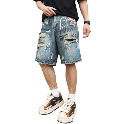 Blue men's jeans shorts with ripped distressed detailing and graffiti design, straight leg cut with zipper fly