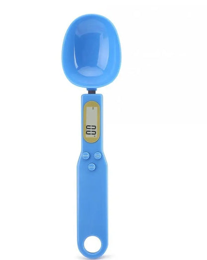 White digital spoon kitchen scale with LCD display showing weight measurement
