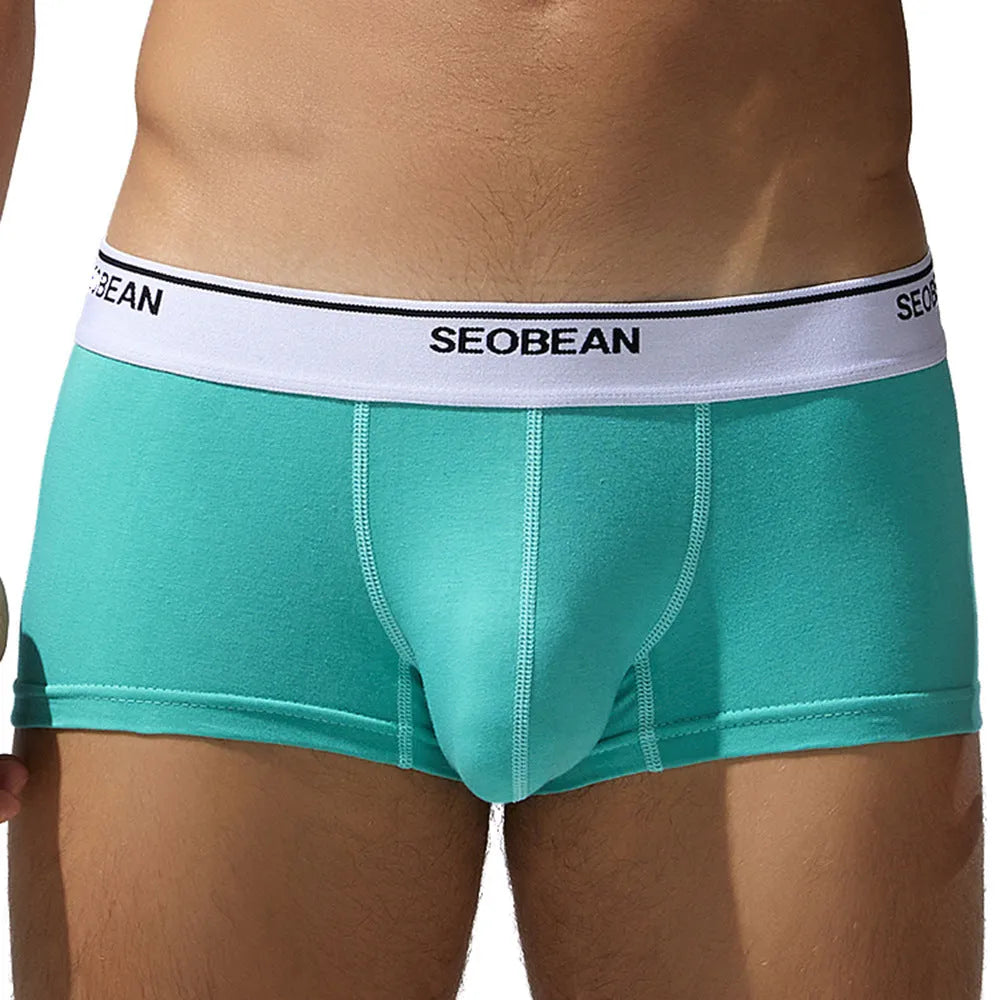 Men's solid colour cotton low waist boxers in sizes M to XXL.