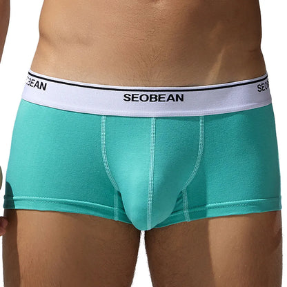 Men's solid colour cotton low waist boxers in sizes M to XXL.