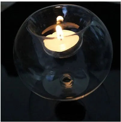 Handmade hollow round glass candle holder in European style on a table.