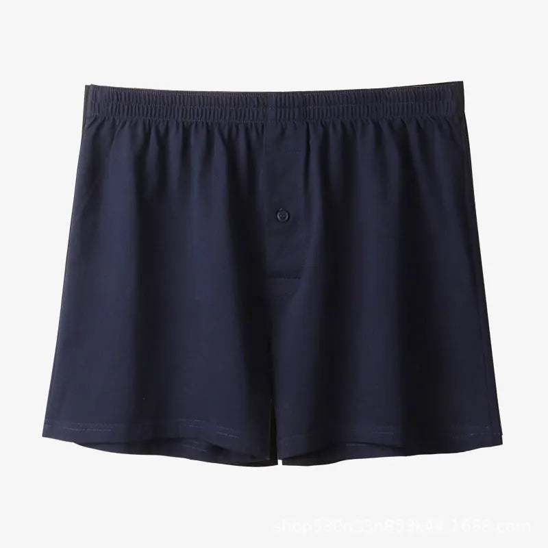 Men's light grey cotton boxer shorts with a loose fit and high waist on a plain background.