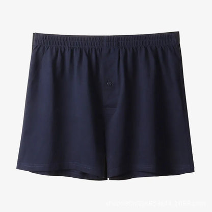 Men's light grey cotton boxer shorts with a loose fit and high waist on a plain background.