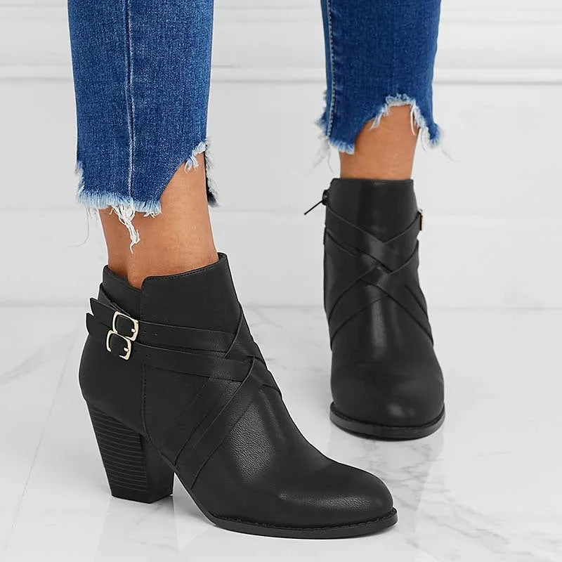 Women's short ankle boots with a belt buckle and side zip in black, brown, or grey with a 7cm heel.