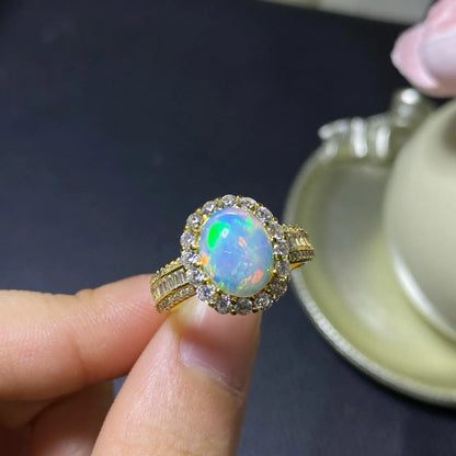 Handmade adjustable silver ring with a natural opal, shown in rose gold, yellow gold, and white gold plated finishes.