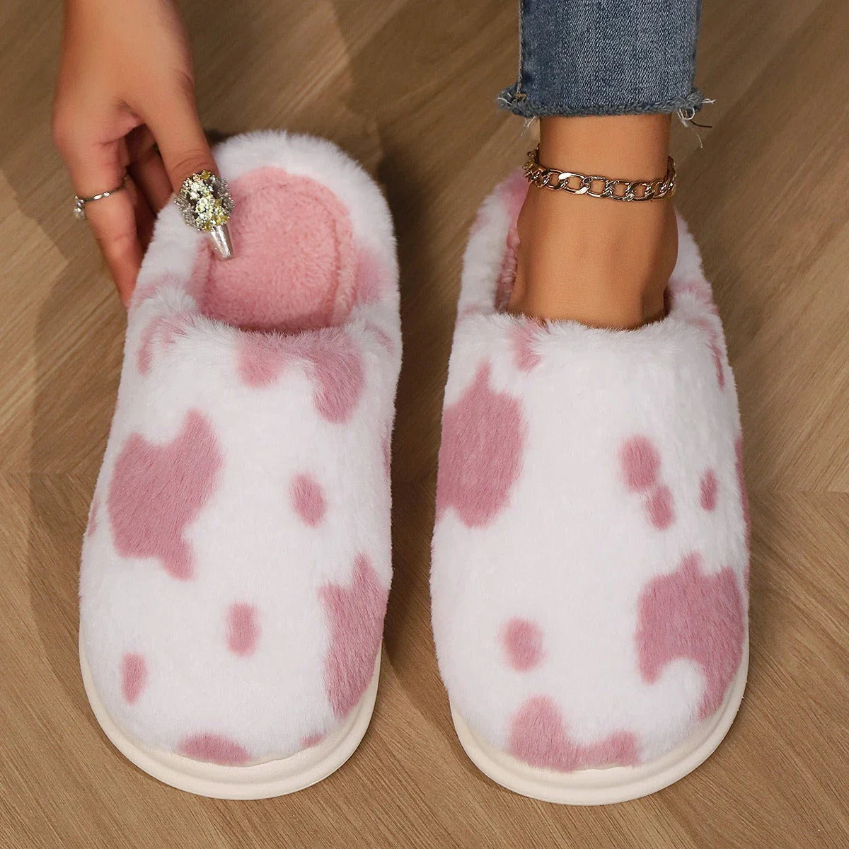 Cozy cow print plush slippers with soft, cushioned soles and non-slip outsoles for indoor comfort and warmth