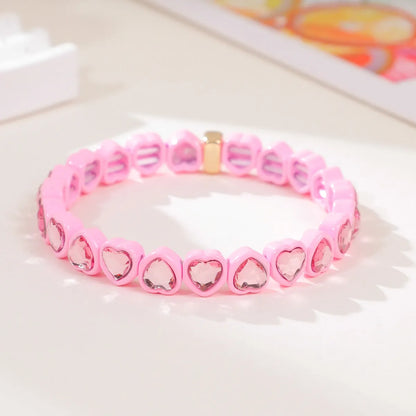 Colourful enamel heart shape on a silver-toned alloy stretch bracelet.