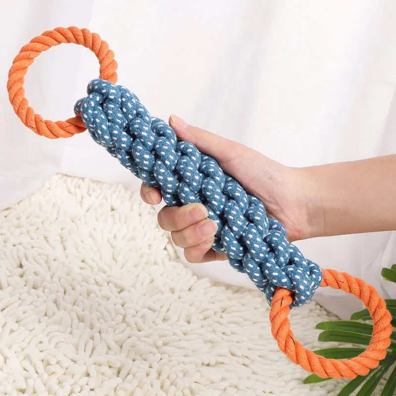 Blue braided bone-shaped cotton rope dog toy with two end rings on a white background.