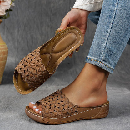 Women's wedge beach slippers with flower cutout design on PVC upper, shown in light brown colour.