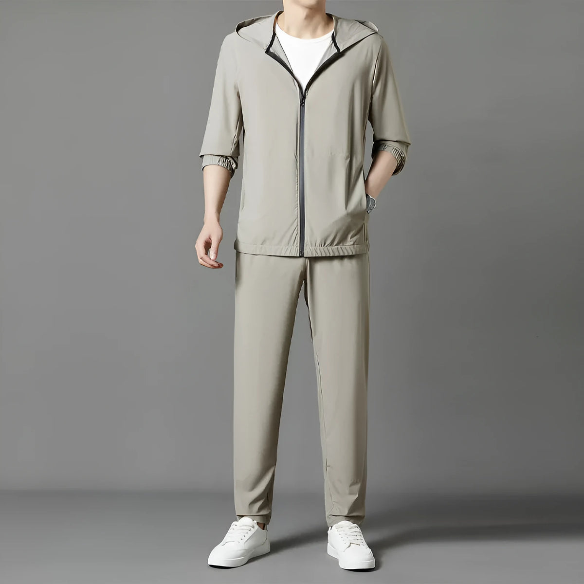 Grey hooded sun-protective top and loose pants suit for men on a hanger.