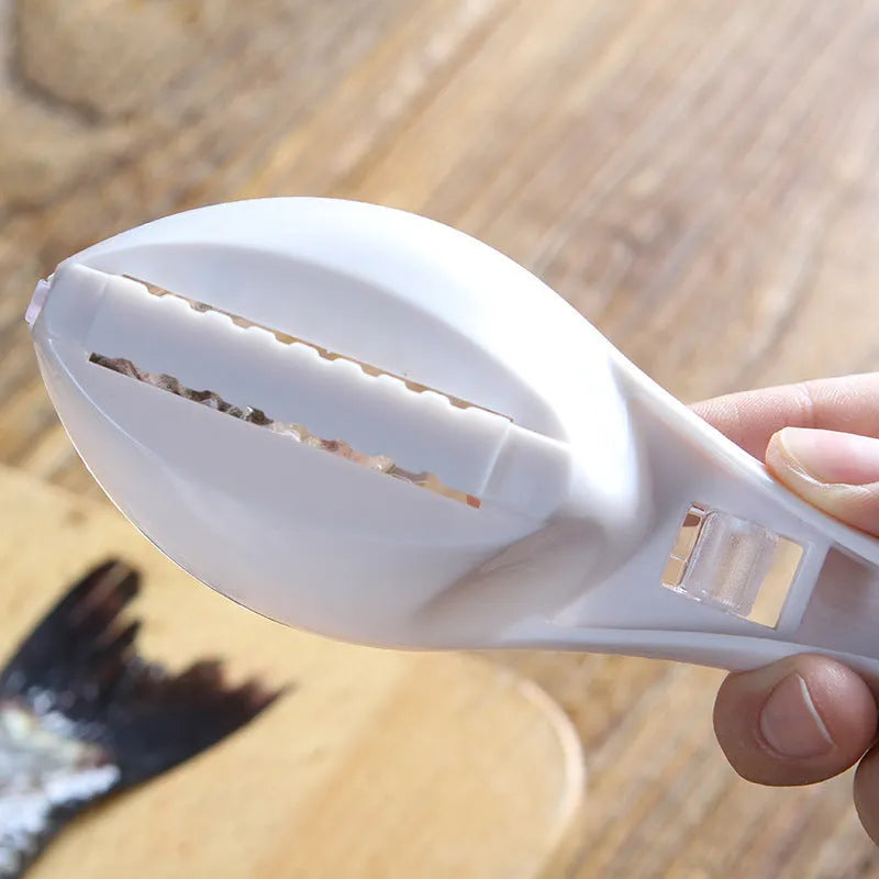 Fish-shaped scaler tool with cover to prevent scale splashing during fish cleaning