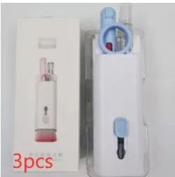 White electronics cleaning kit with a cleaning pen, spray bottle, brush, and keycap puller on a table