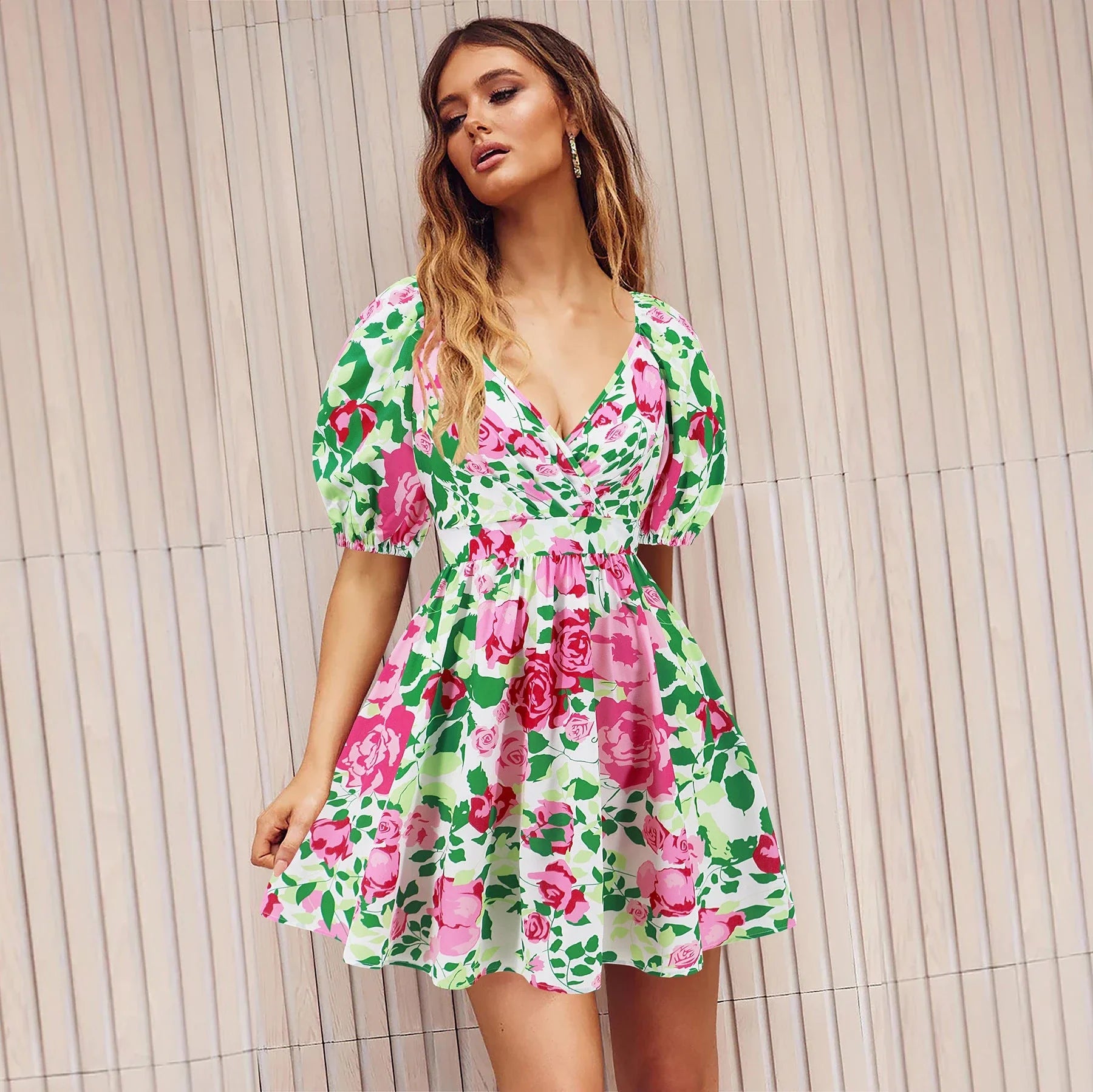 Stylish floral mini dress with V-neck and lantern sleeves, perfect for summer vacations and beach outings