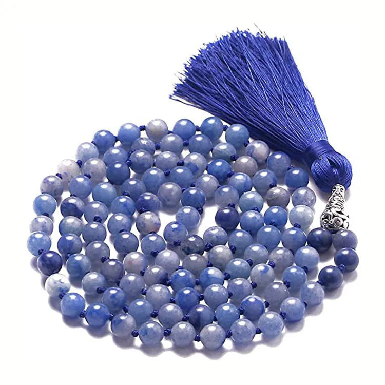 Long multi-coloured agate and stone tassel necklace with geometric beads on a white background.