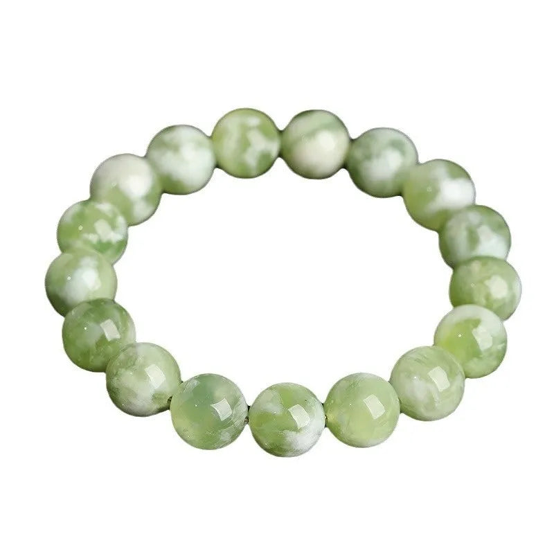 Green milk-in-water Xiuyan jade bracelet with polished geometric beads.