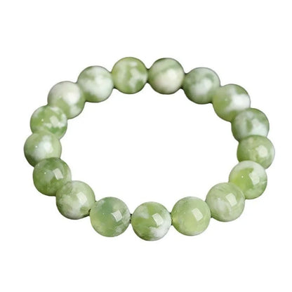 Green milk-in-water Xiuyan jade bracelet with polished geometric beads.