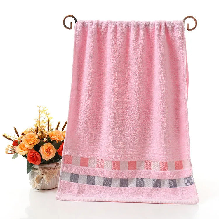 Cotton face towel in blue, pink and yellow colours with heart patterns, dimensions 73x33cm