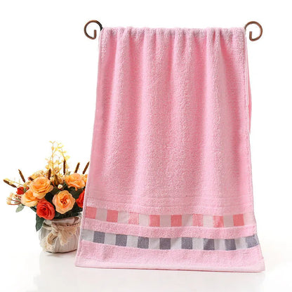 Cotton face towel in blue, pink and yellow colours with heart patterns, dimensions 73x33cm