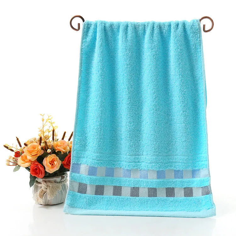 Cotton face towel in blue, pink and yellow colours with heart patterns, dimensions 73x33cm