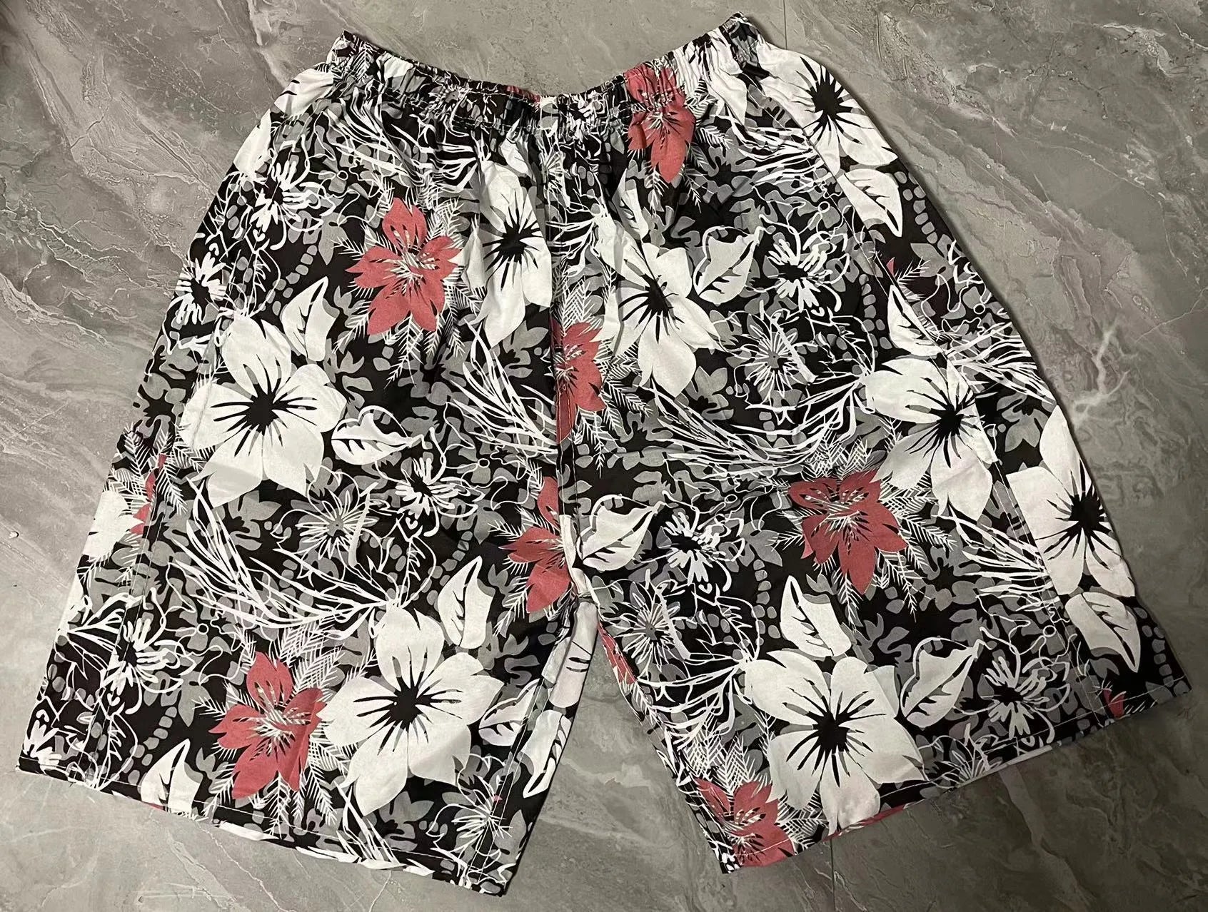 Men's floral patterned swim shorts with five-point cut design